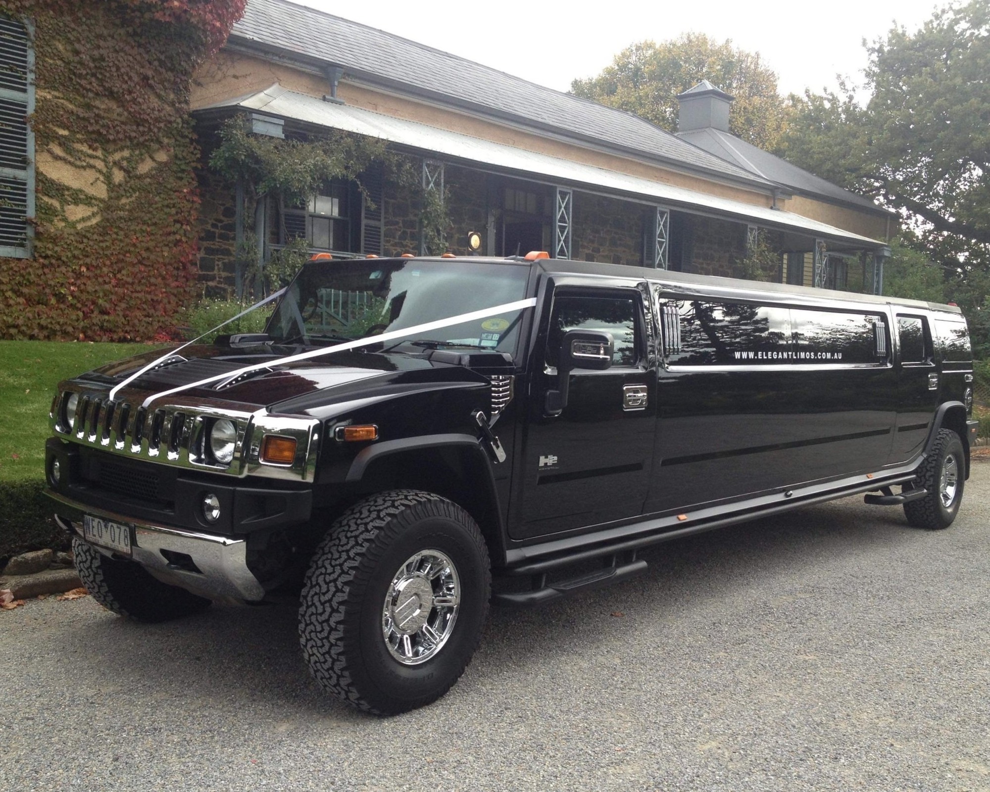 Black Hummer H2 stretch limousine with wedding ribbons