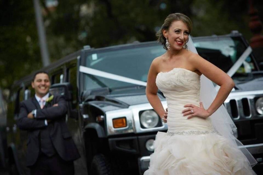 Bride beside the limousine