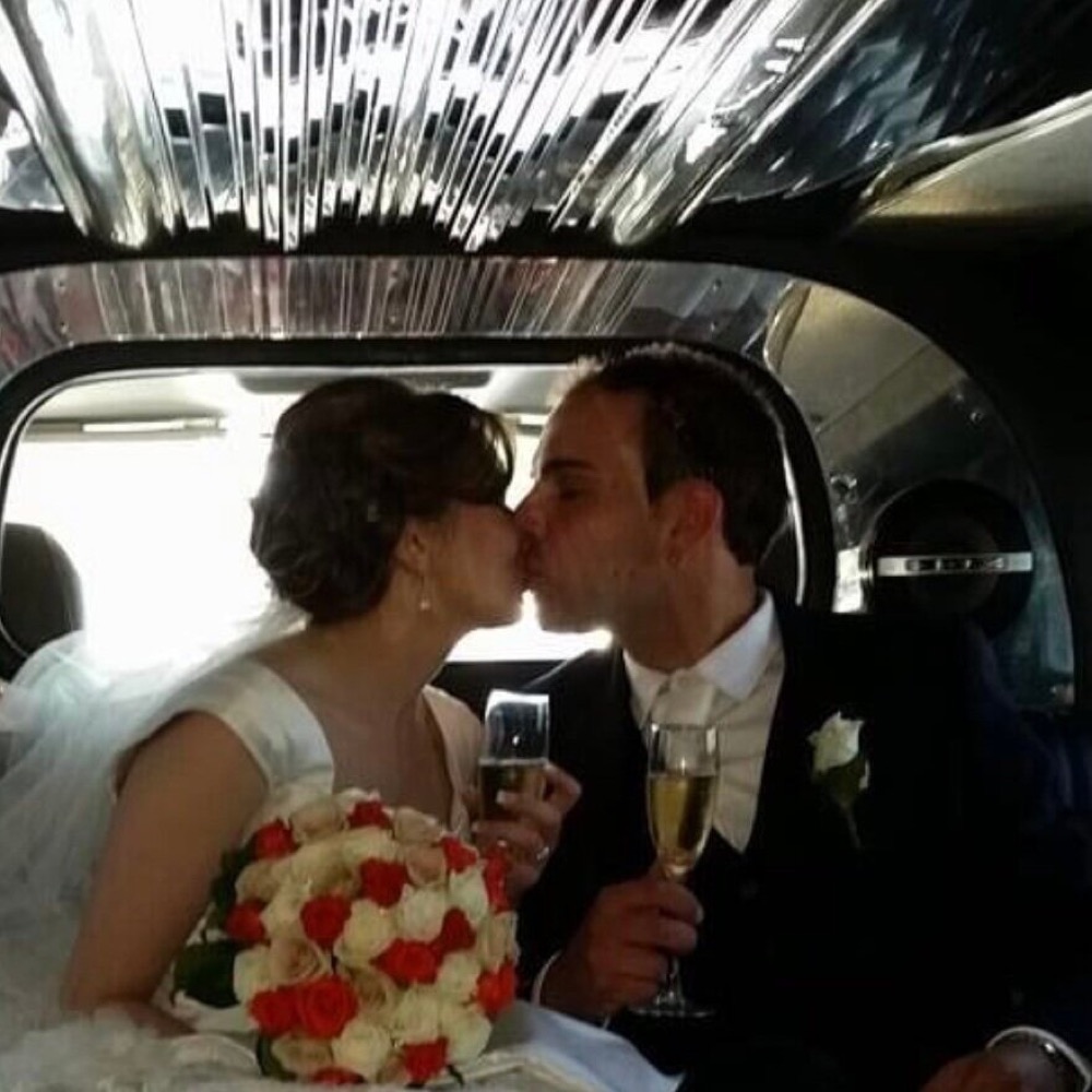 Newlyweds toasting inside the limousine